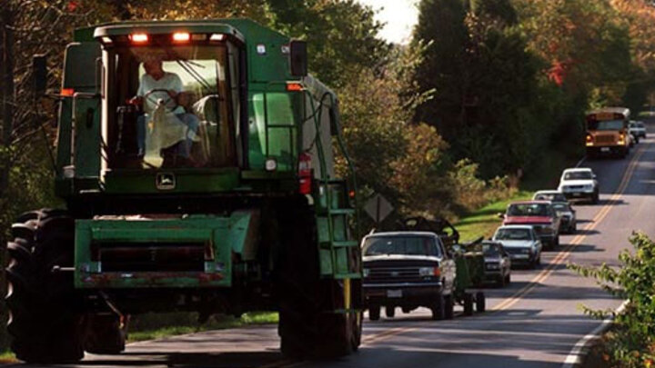 Tractor driving on a highway.