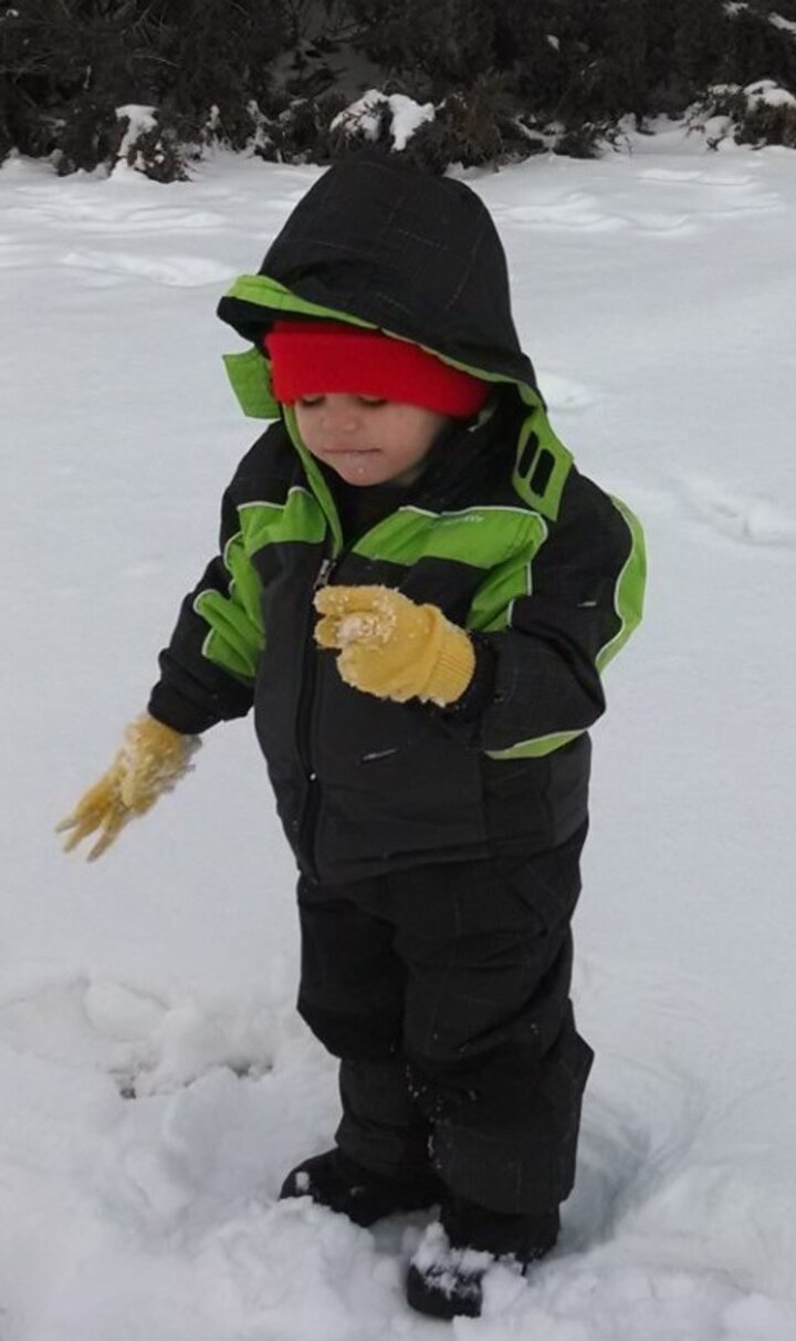 Boy playing in the snow.